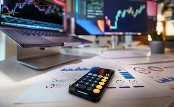 Financial market charts and calculator representing institutional RWA swaps