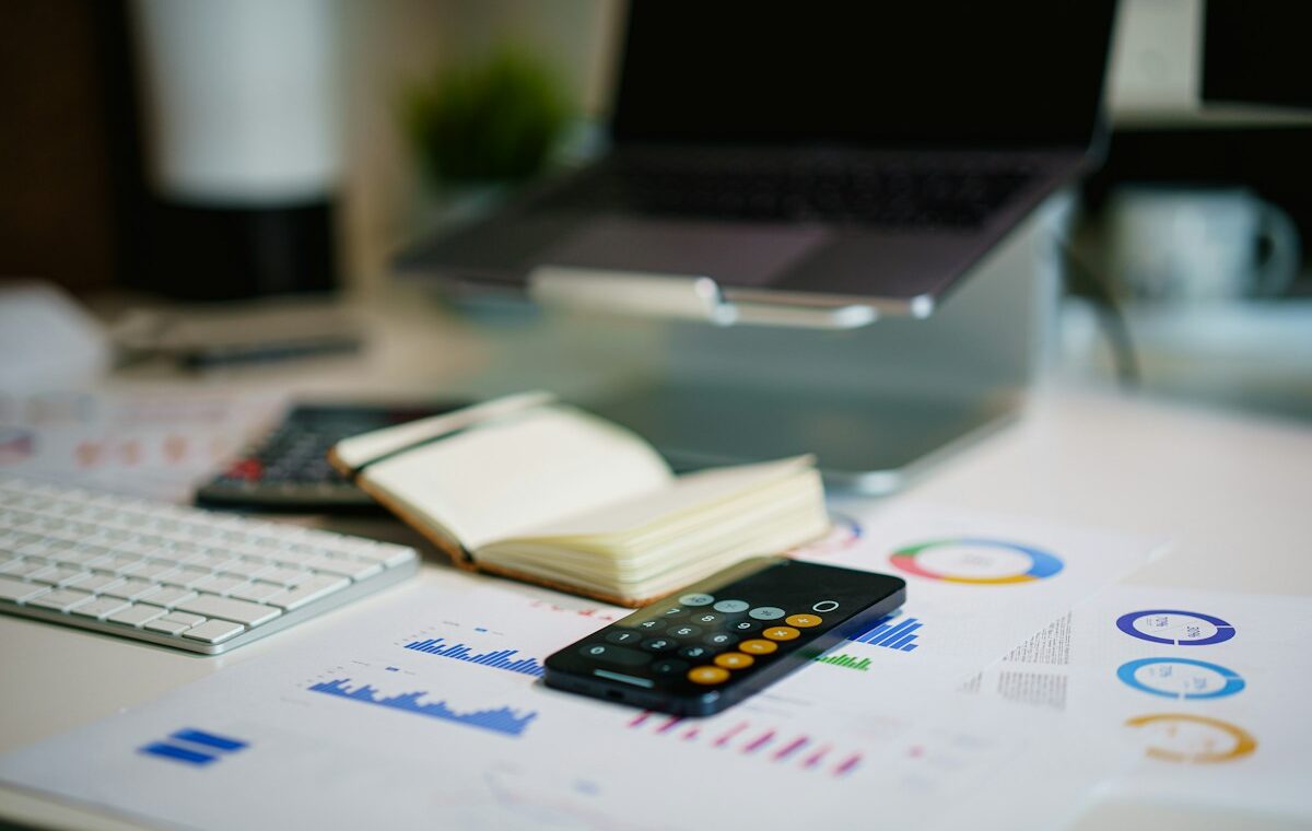 Calculator and financial reports used to analyze interest coverage ratio