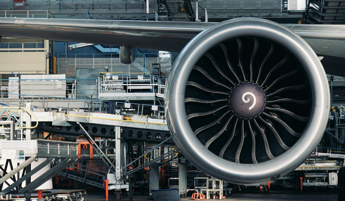 Large commercial jet engine inside an aircraft maintenance hangar