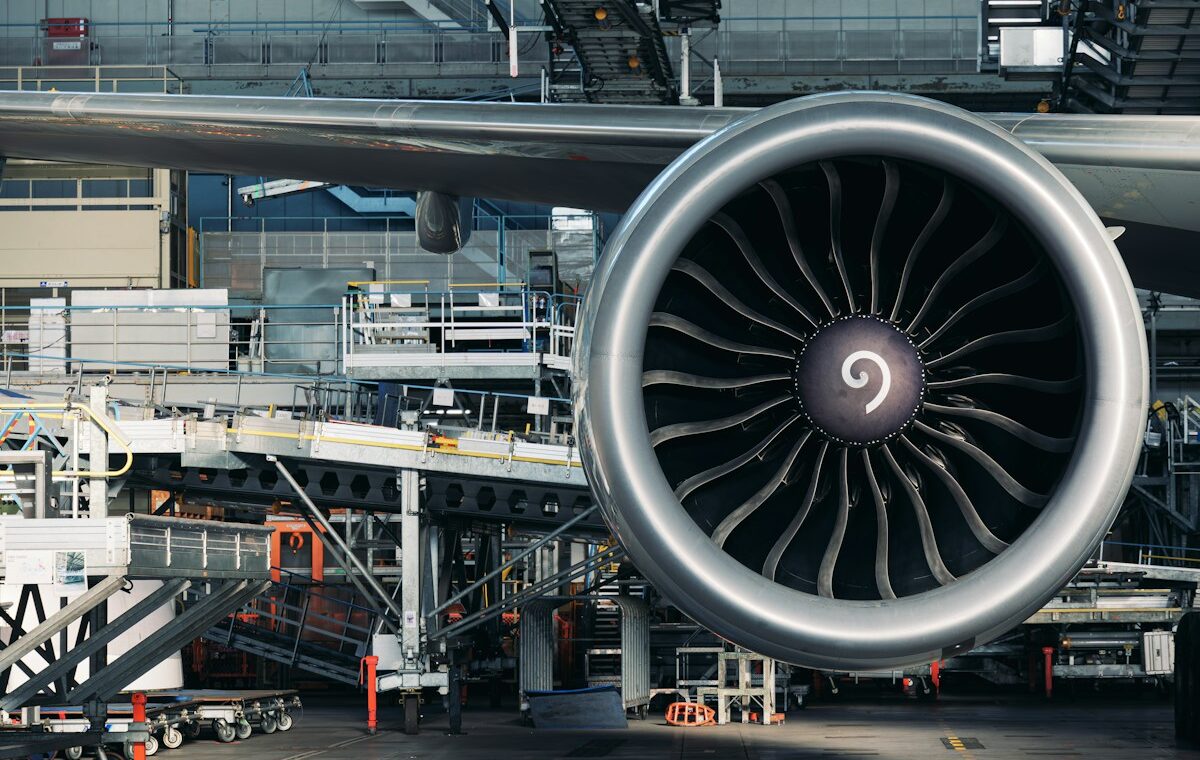 Large commercial jet engine inside an aircraft maintenance hangar