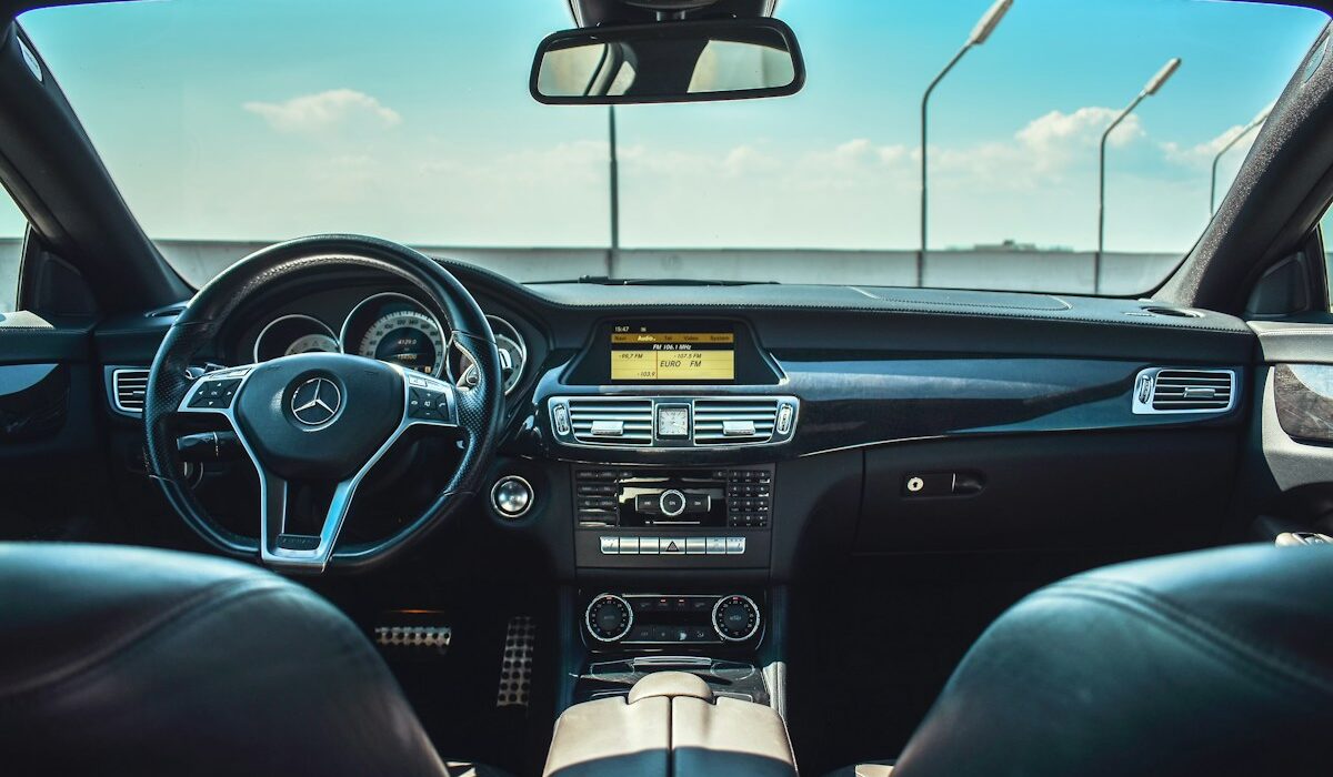 Mercedes-Benz steering wheel and digital dashboard viewed from the rear seats