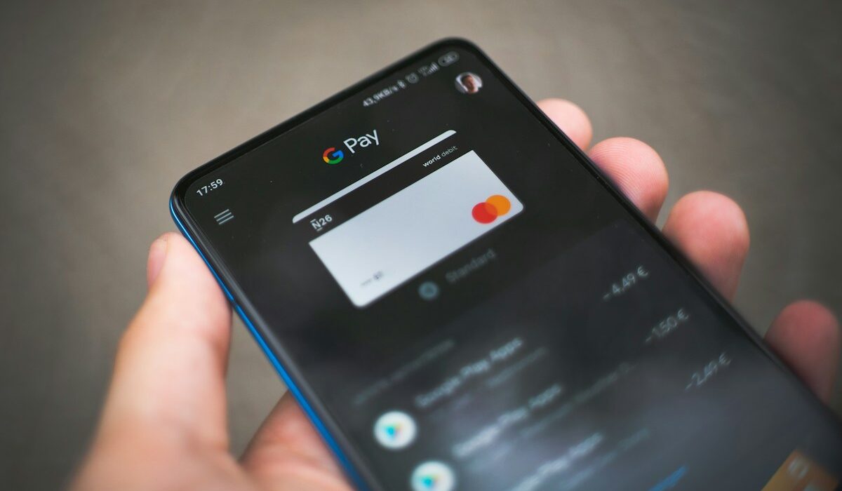 Person holding a smartphone with a digital payment app open