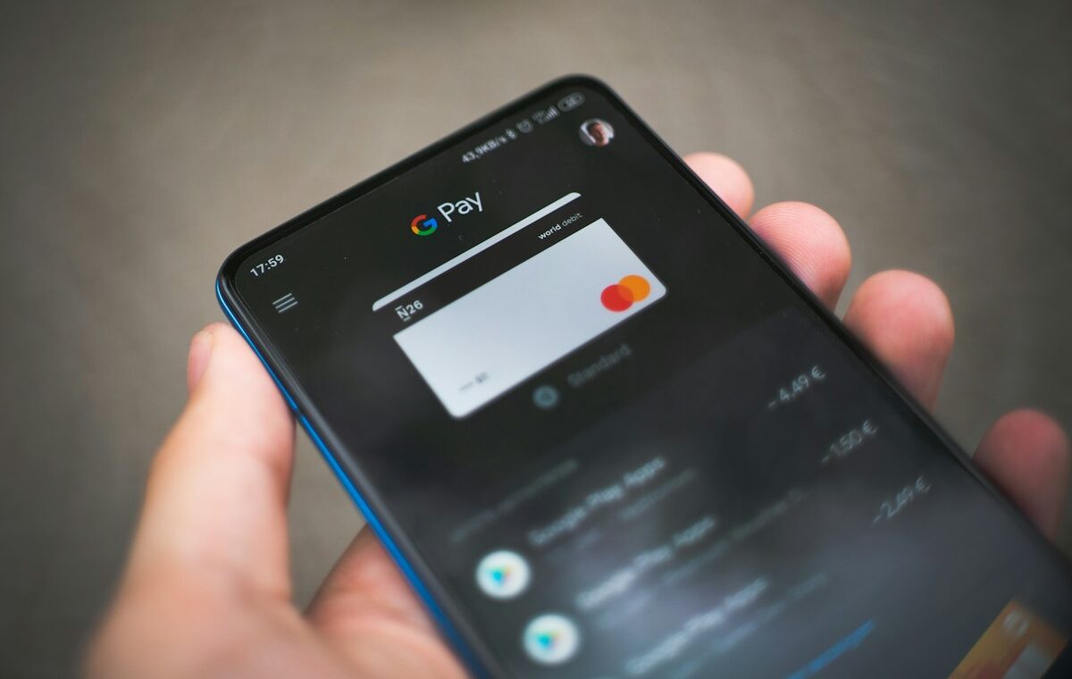 Person holding a smartphone with a digital payment app open
