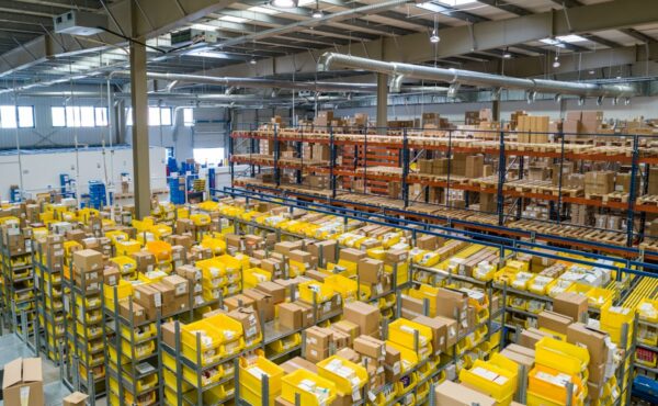 Large logistics warehouse filled with shelves and packages