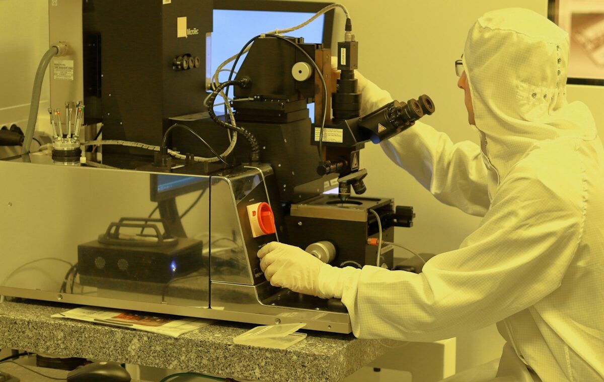 Engineer operating semiconductor equipment in an NVIDIA AI-defined fab cleanroom