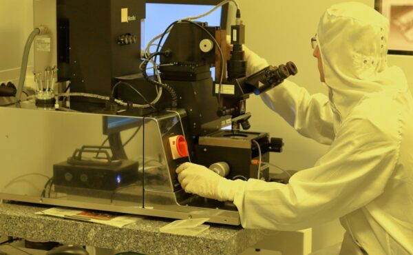 Engineer operating semiconductor equipment in an NVIDIA AI-defined fab cleanroom