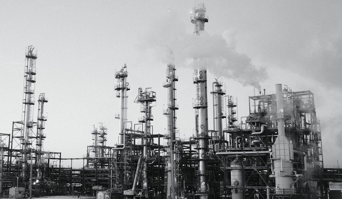 Large oil refinery complex with processing towers and industrial stacks