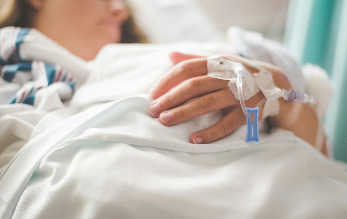Option Care Health acquisition represented by a patient receiving an intravenous infusion