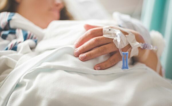 Option Care Health acquisition represented by a patient receiving an intravenous infusion