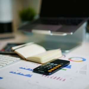 Financial reports and calculator used to analyze price-to-sales ratios