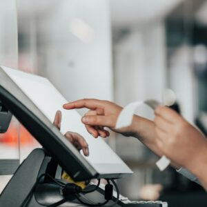 Retail worker using a checkout terminal as September U.S. sales rise