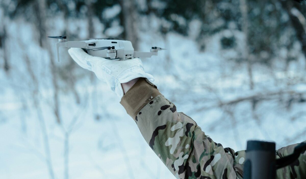 Field operator preparing a commercial drone representing Safe Pro defense AI deployments