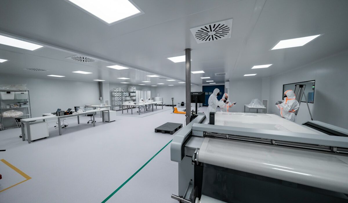 Technicians working inside a semiconductor manufacturing cleanroom