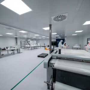 Technicians working inside a semiconductor manufacturing cleanroom