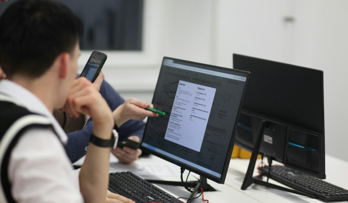 Students reviewing digital learning data on a classroom monitor