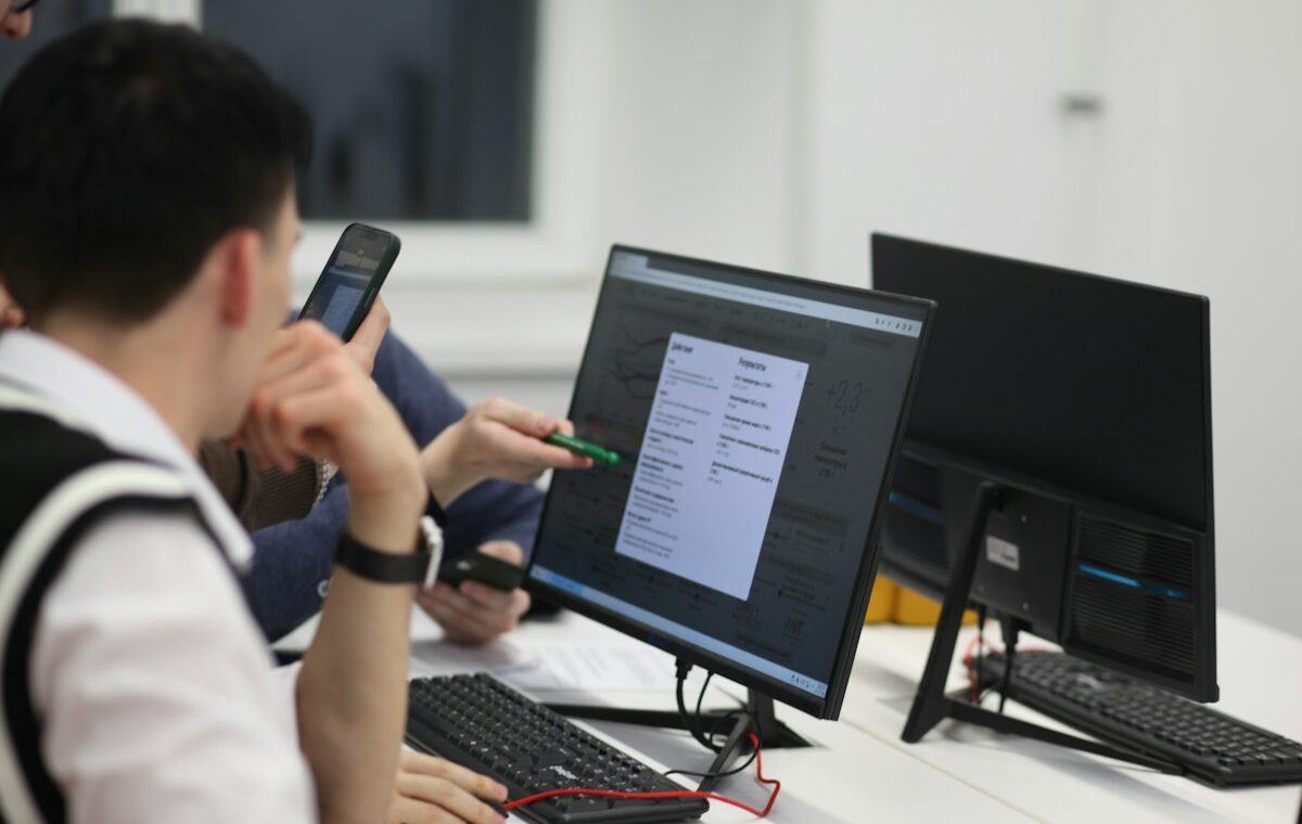 Students reviewing digital learning data on a classroom monitor