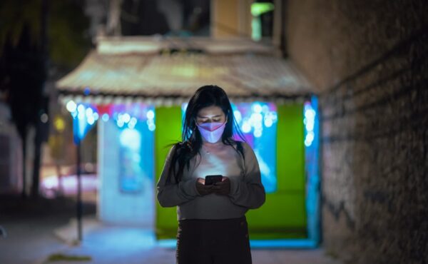Smartphone user representing stablecoin payment infrastructure across Latin America