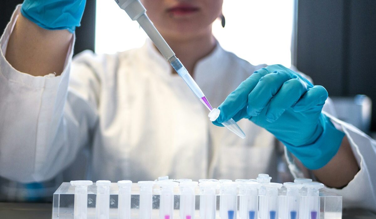 Laboratory scientist using a pipette, illustrating Thermo Fisher revenue growth