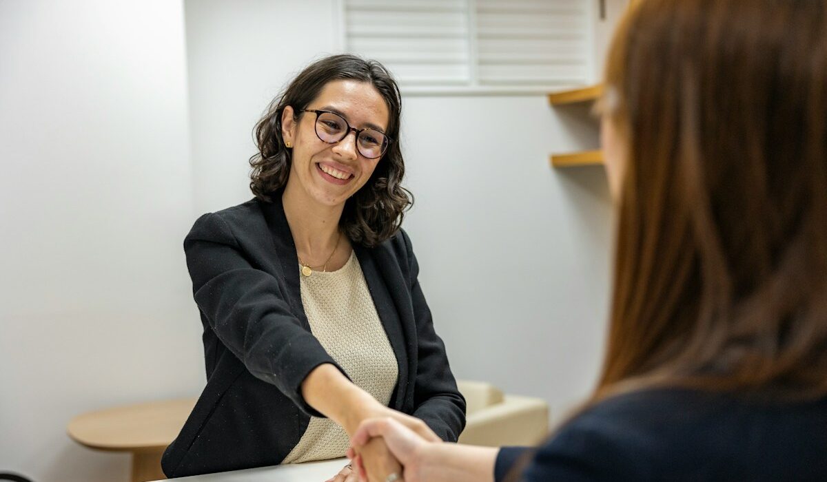 Unemployment rate explained with a job candidate shaking hands after an interview