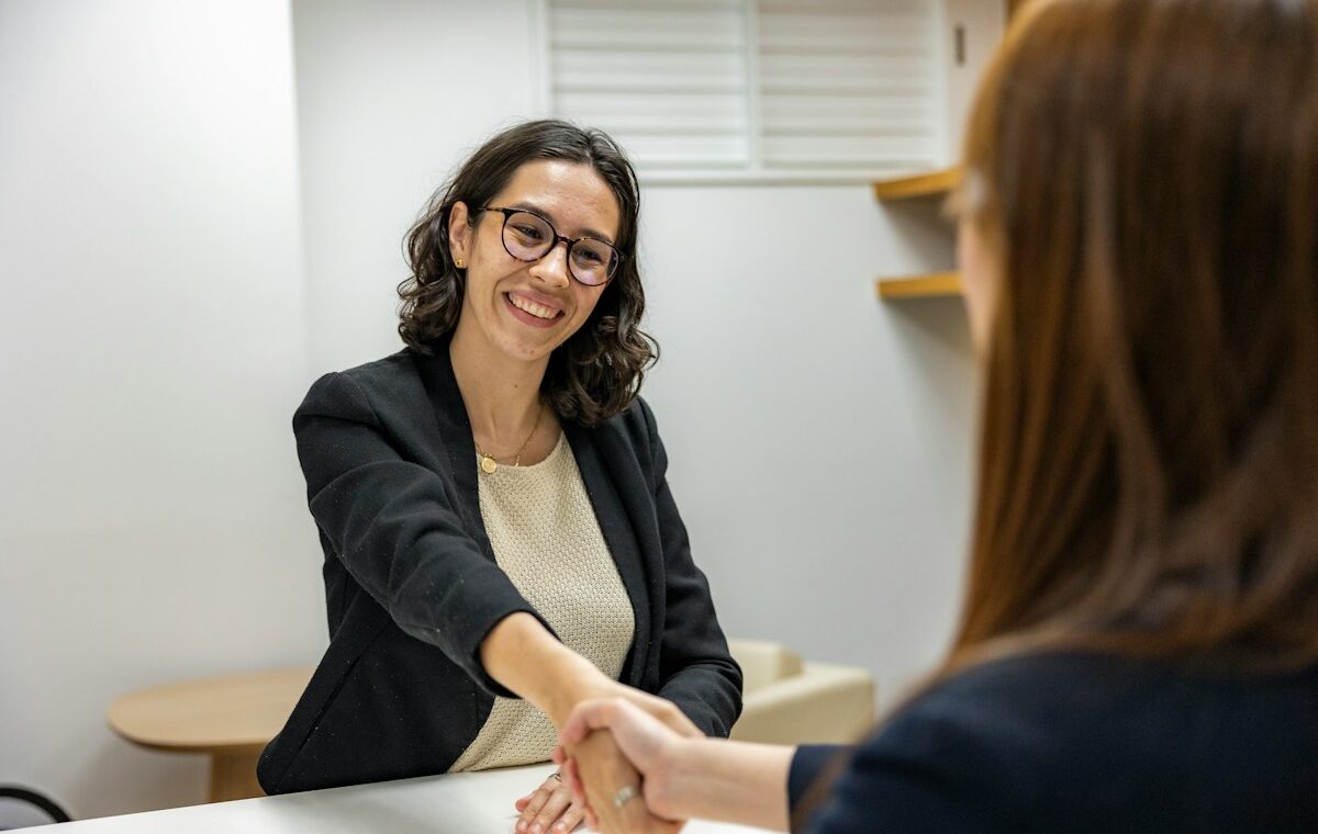 Unemployment rate explained with a job candidate shaking hands after an interview