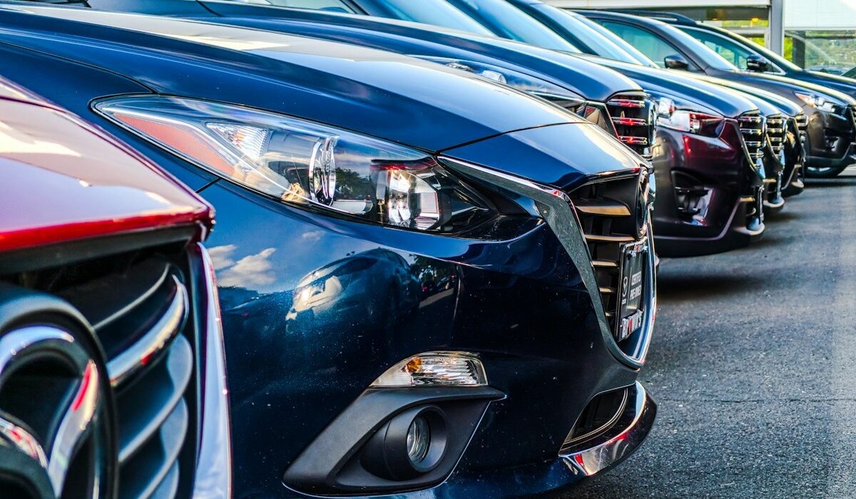 Rows of dealership vehicles illustrating the Greenway Auto settlement. Photo by Obi on Unsplash.