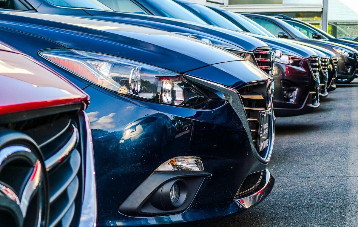 Rows of dealership vehicles illustrating the Greenway Auto settlement. Photo by Obi on Unsplash.