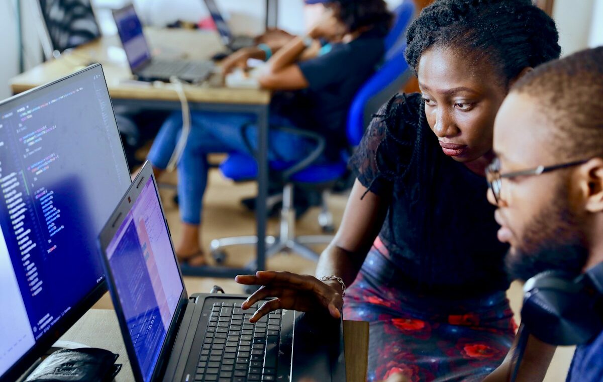 Technology professionals at computers illustrating the West Africa scam takedown
